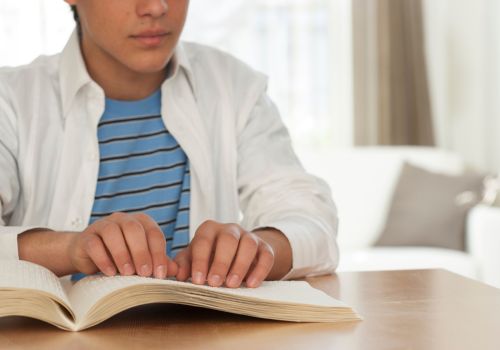 A person reading a braille textbook